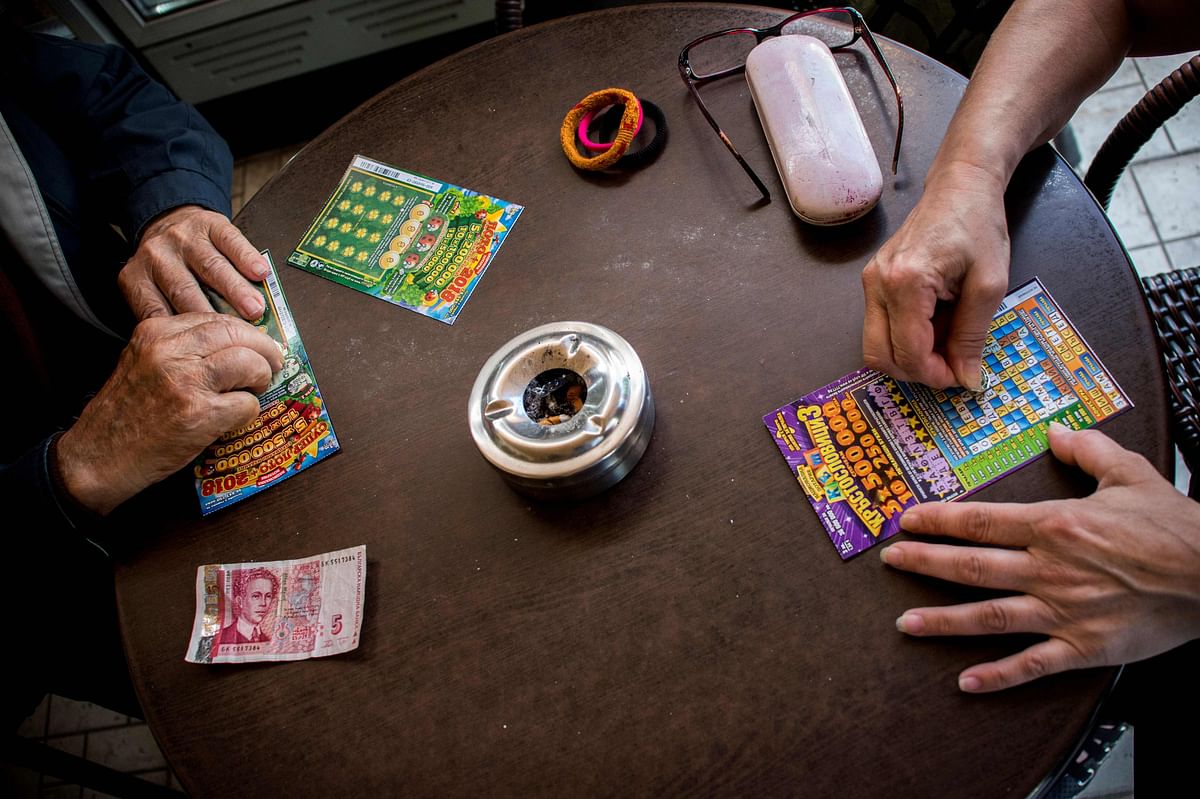 Stoyan Stoimenov, 96, buys scratch cards at a local coffee shop in the village of Tsurkva, near the capitol of Sofia, on May 28, 2018. Stoimenov is just one of thousands of Bulgarians who have been gripped by a craze for scratch cards in recent years in the EU`s poorest member state, with some now raising the alarm over the dangers of widespread addiction. According to an estimate by Bulgaria`s Capital financial weekly, 100 million scratch cards were sold in 2017 in a country of less than seven million people. Photo: AFP