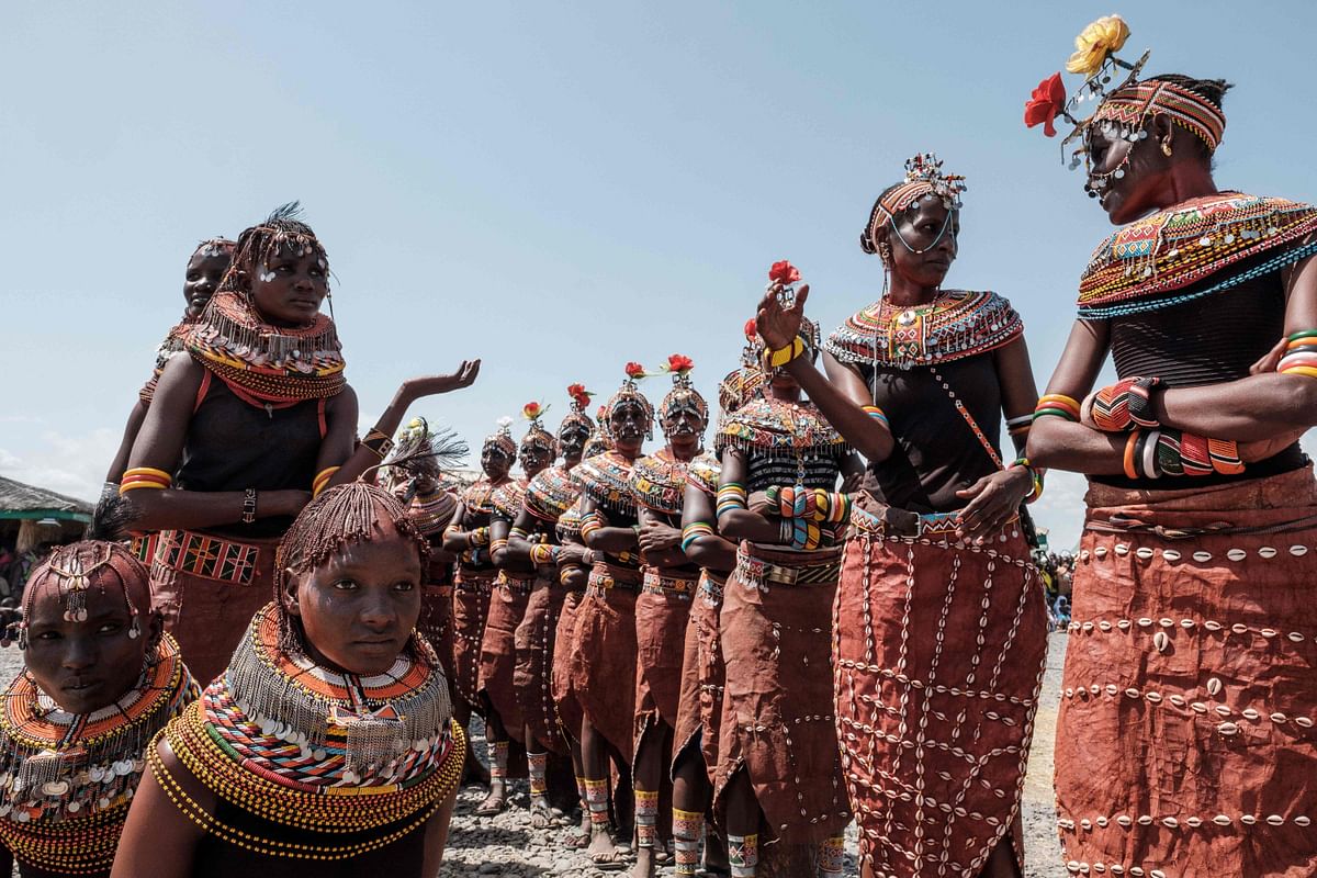 Women of Rendile tribe (Right line) and Turkana tribe wait for their collaborated dance performance during the 11th Marsabit Lake Turkana Culture Festival in Loiyangalani, northern Kenya, on 28 June 2018. The annual 3-day festival features the cultural traditions of 14 ethnic tribes in Marsabit county to promote tourism and build better relationship between tribes. Photo: AFP
