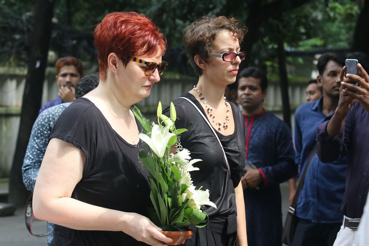 This 1 July Photo shows officials of foreign missions and embassies in Dhaka make their way into Holey Artisan Bakery ground in the capital’s Gulshan with flowers to commemorate the victims of deadly terrorist attack at Holey Artisan Bakery. Photo: Abdus Salam