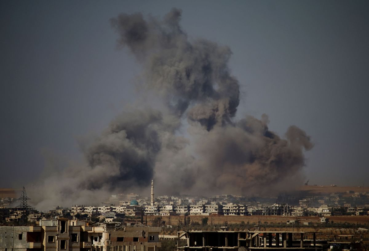 Smoke rises above a rebel-held town east of the city of Daraa during airstrikes by Syrian regime forces on 30 June 2018. At least eight battered rebel-held towns in southern Syria returned to regime control under Russian-brokered deals after nearly two weeks of bombardment, a Britain-based monitor said. Photo: AFP