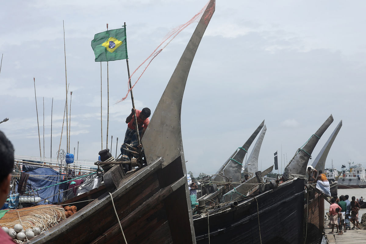 A Brazil fan hoists the flag of his favourite team ahead of the Brazil vs Mexico match to reach FIFA World cup quarter finals. Saurabh Das took this photo from Fishery Ghat in Chattogram.