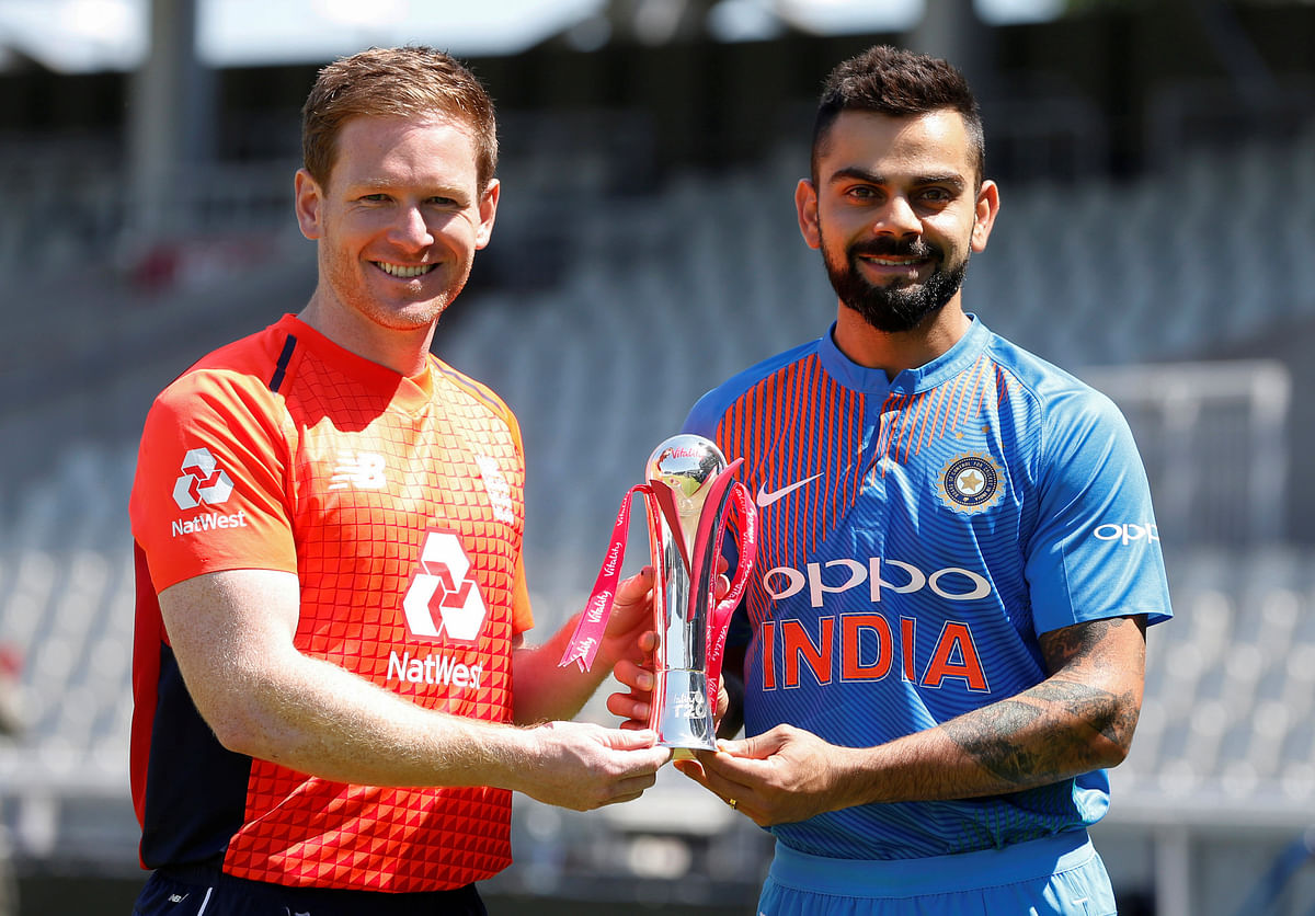 England`s Eoin Morgan and India`s Virat Kohli pose with the series trophy at Emirates Old Trafford, Manchester, Britain on 2 July 2018. Photo: Reuters