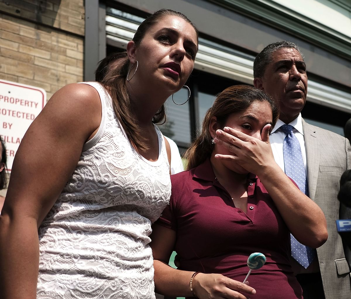 Yeni Maricela Gonzalez Garcia (center) stands with Janey Pearl and Democratic Congressman Adriano Espaillat as she speaks with the news media following a visit with her children at the East Harlem Cayuga Centers on 3 July 2018 in New York City. Photo: AFP