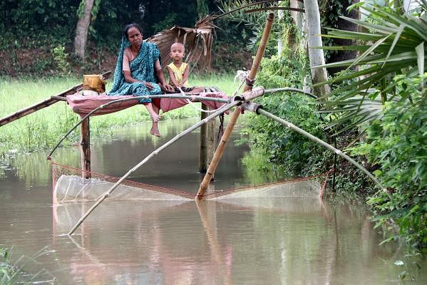 Monsoon rain has filled a local canal in Ashekpur, Shahjahanpur, Bagura. An elderly woman has set a net in the canal for fishing and observes sitting with his son-in-law. The picture was taken on 4 July by Soel Rana.
