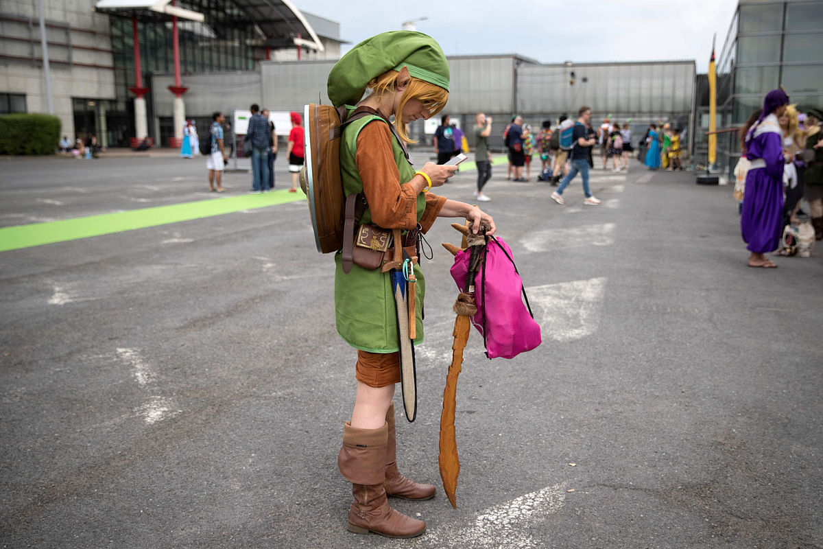 A cosplayer checks her phone as she arrives for a contest at the 2018 Japan Expo exhibition on 5 July in Villepinte, near Paris. Photo: AFP