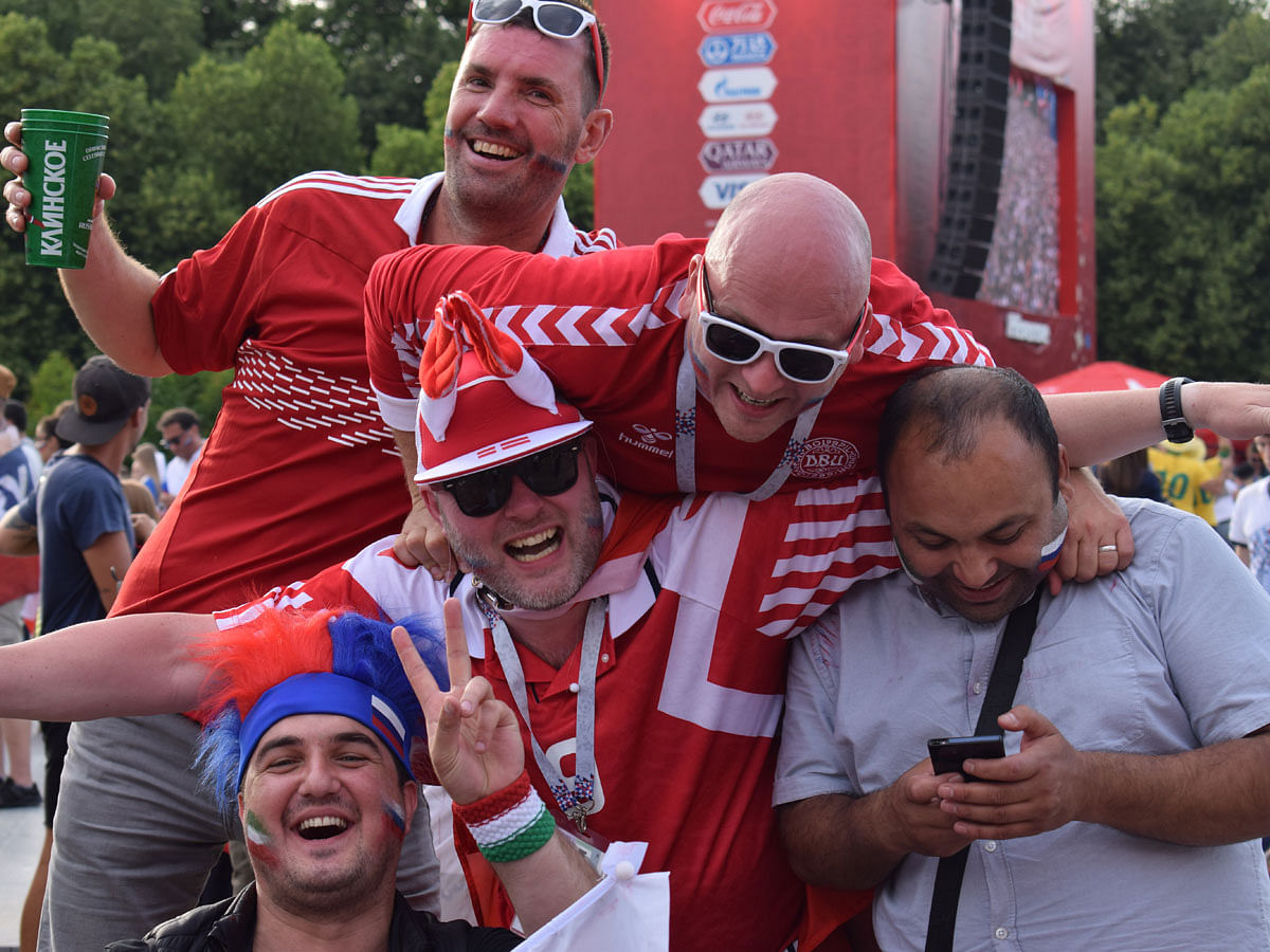 Denmark and Russia fans enjoy their time together. Photo : Quamrul Hassan