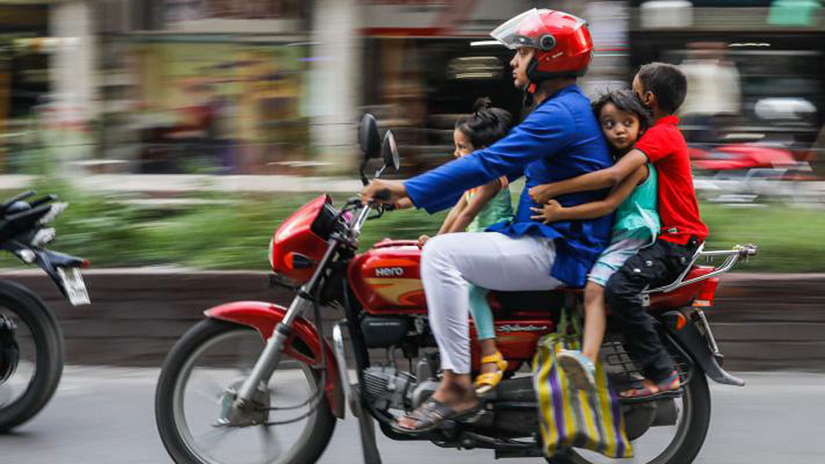 A man drives a motorbike with three children riding on the vehicle. A small mistake can take a heavy toll. The picture was taken from Panthapath, Dhaka on 6 July by Dipu Malakar