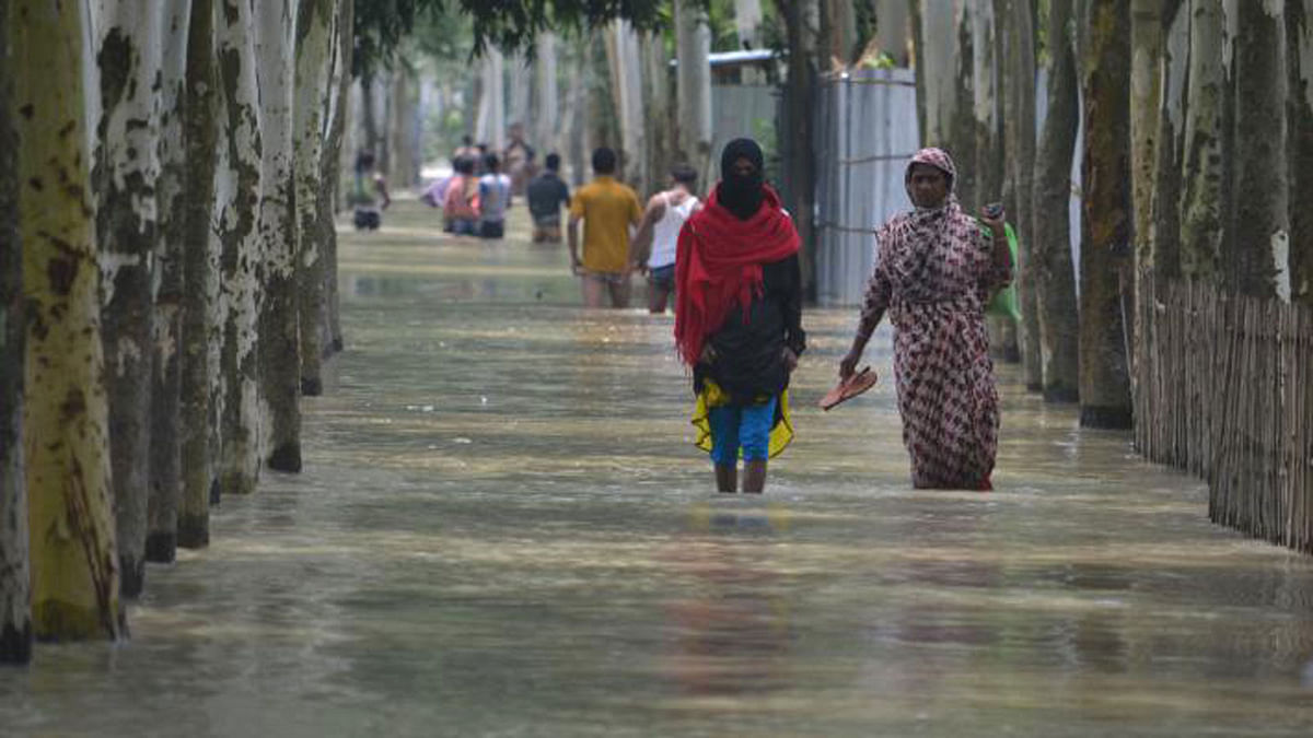 Floodwater has inundated localities. People wade through floodwater with difficulty. The picture was taken by Safi Khan from Kaim Boraibari, Bhogdanga, Kurigram on 6 July