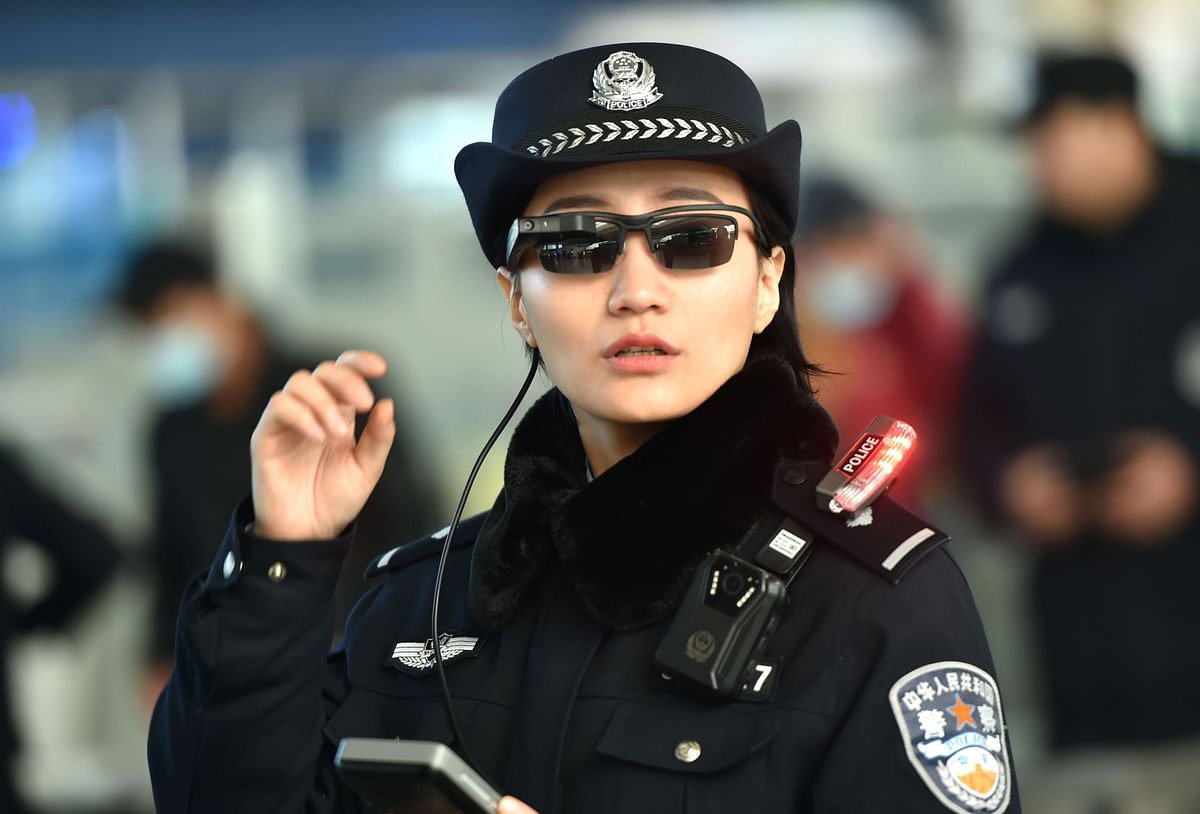 This file photo taken on 5 February 2018 shows a police officer wearing a pair of smartglasses with a facial recognition system at Zhengzhou East Railway Station in Zhengzhou in China`s central Henan province. Photo: AFP