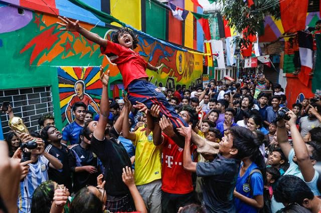 A young boy is tossed in the air as part of the celebrations.