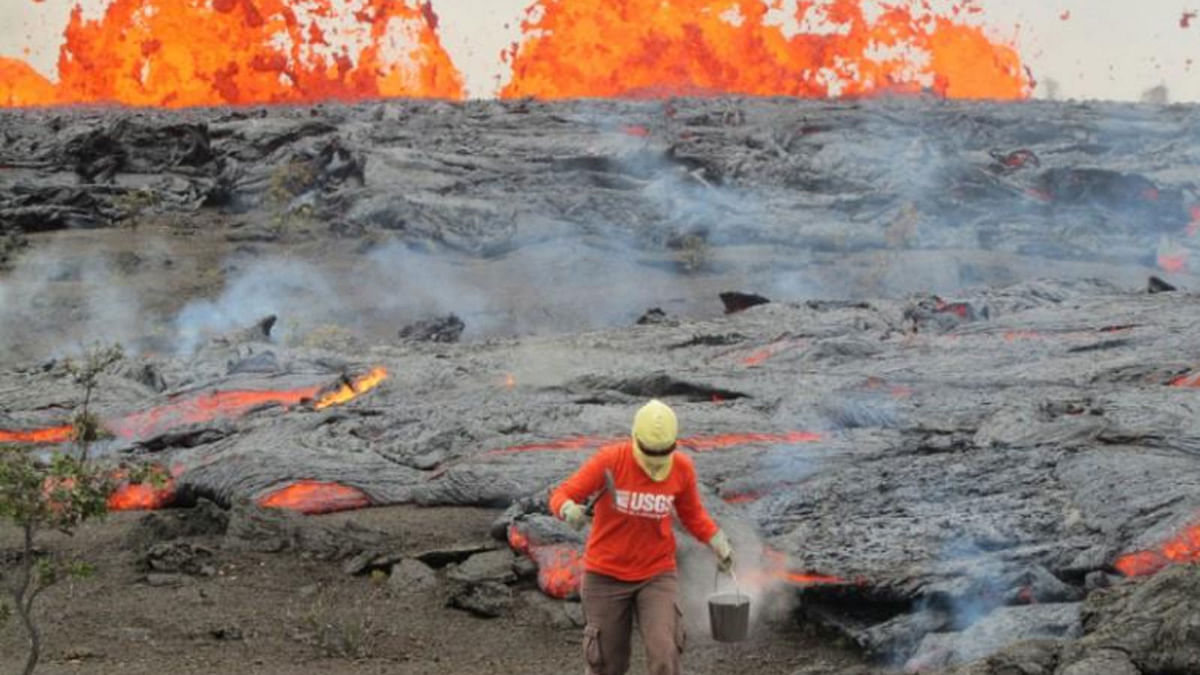 A geologist is collecting sample of molten lava from 2011 Kamoamoa eruption, at Kilauea Volcano, Hawaii, US, on 6 March 2011. Courtesy USGS/Reuters