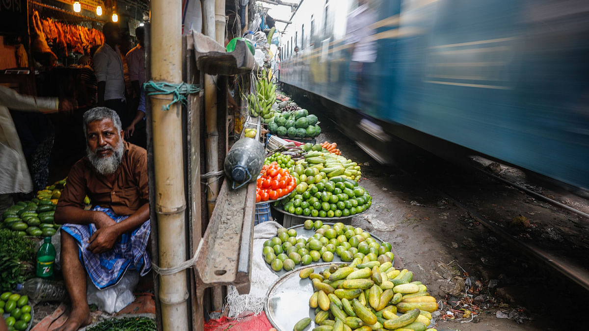 Despite huge risk of accident, venders sell vegetables on both side of railway tracks in Jurain, Dhaka. Dipu Malakar takes this photo on 8 July.