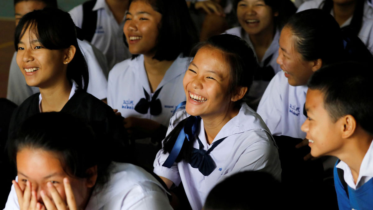 Classmates react after a teacher announces that some of the 12 schoolboys who were trapped inside a flooded cave, have been rescued, at Mae Sai Prasitsart school, in the northern province of Chiang Rai, Thailand on 9 July. Photo: Reuters
