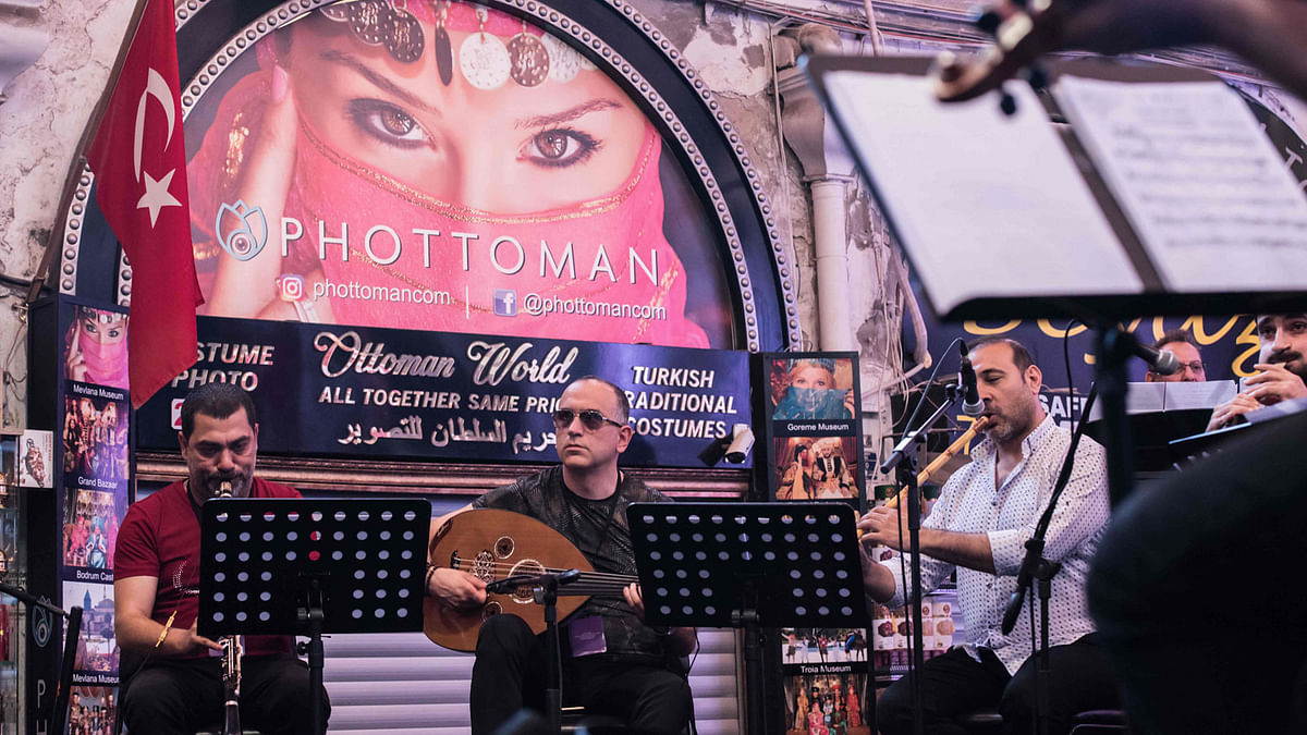 Melodies of Istanbul` orchestra perform during a rehearsal ahead of the 46th edition of Istanbul Music Festival at the Grand Bazaar, exceptionally open on a Sunday, during an interview with AFP on 3 June 2018 in Istanbul. Photo: AFP