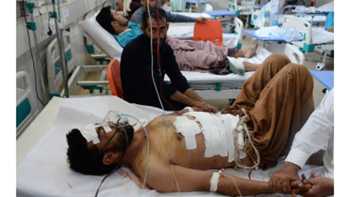 Afghan victims receive treatment at a hospital following a suicide attack in Jalalabad on 10 July 2018.