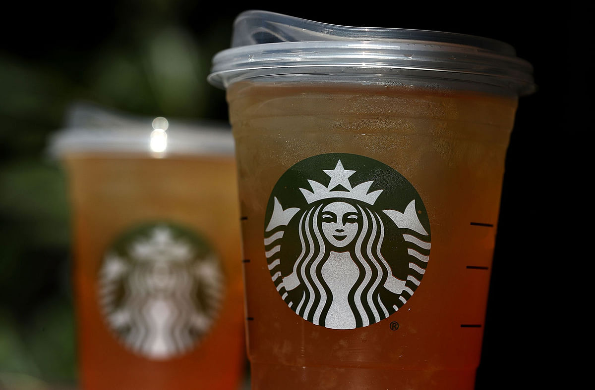 A new flat plastic lid that does not need a straw is shown on a cup of Starbucks iced tea on 9 July in Sausalito, California. Photo: AFP