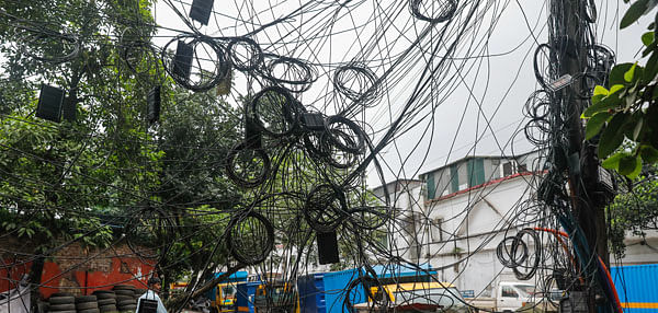 A 10 July 2020 photo shows jungle of twisted cables hanging from an electric pole by Shahid Tazuddin Ahmed Sarani in Dhaka, increasing risk of accidents