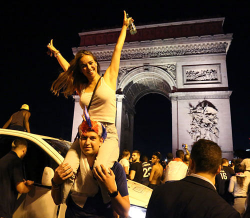 People celebrate France`s 1-0 victory on the Champs Elysee in Paris on July 10, 2018, after the final whistle of the Russia 2018 World Cup semi-final football match between France and Belgium. Photo: AFP