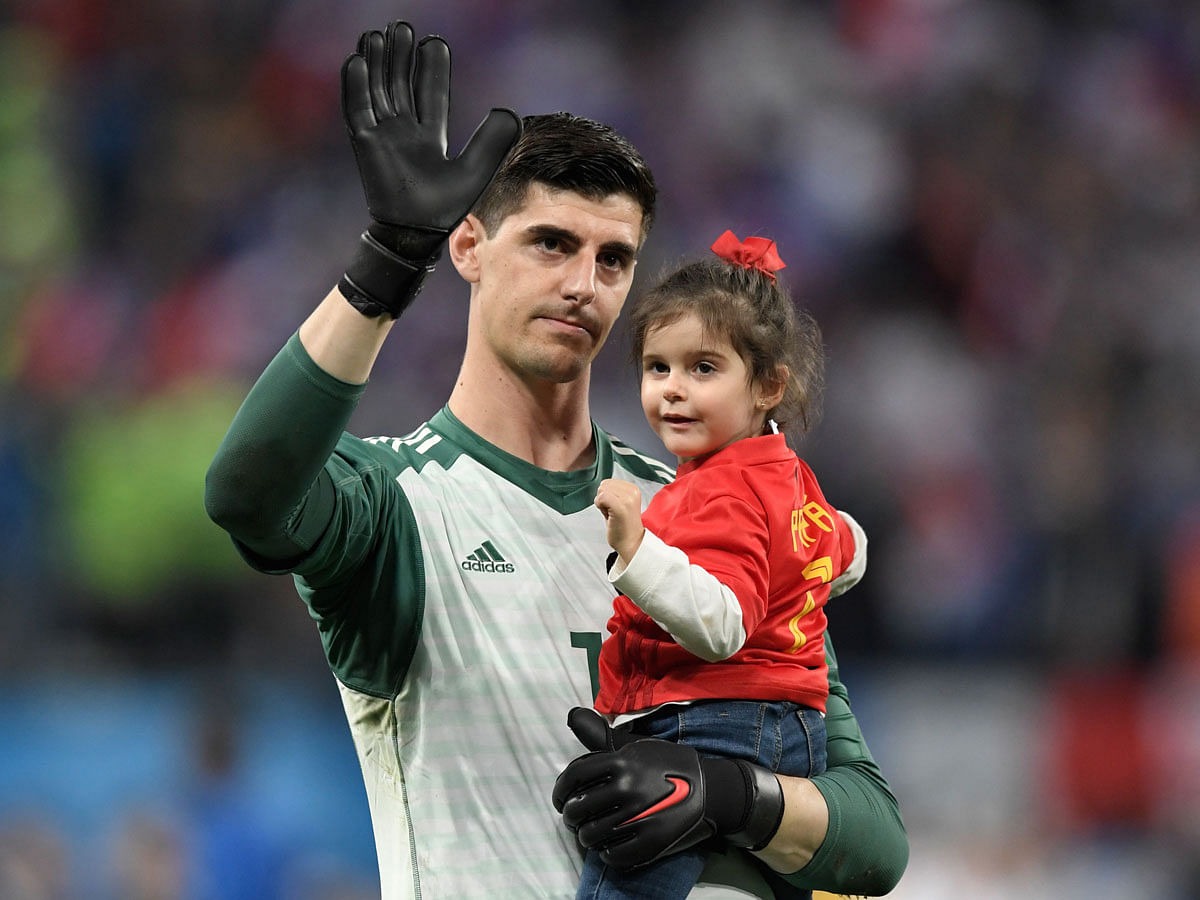Belgium goalkeeper Thibaut Courtois carries his daughter, Adriana, as he greets the fans after their defeat in the Russia 2018 World Cup semi-final against France at the Saint Petersburg Stadium on July 10, 2018. AFP