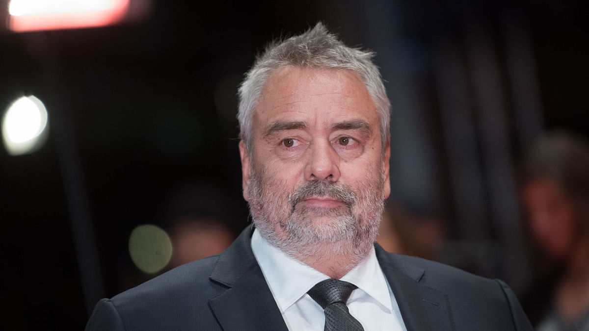 In this file photo taken on 17 February, 2018 French director Luc Besson poses on the red carpet upon arrival for the premiere of the film “Eva” presented in competition during the 68th Berlinale film festival in Berlin