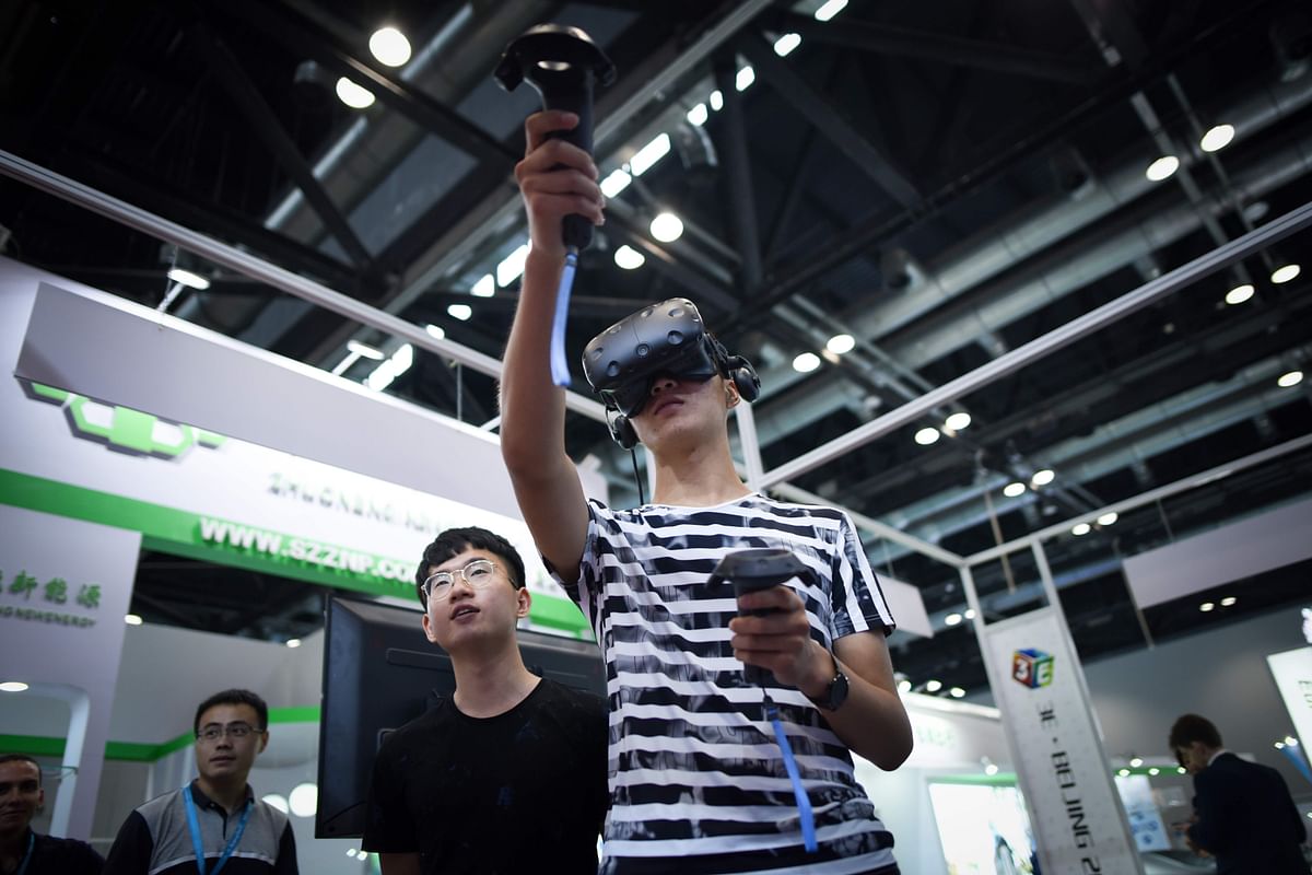A man uses a Virtual Reality equipment at Beijing International Consumer Electronics Expo in Beijing on 9 July 2018. Photo: AFP