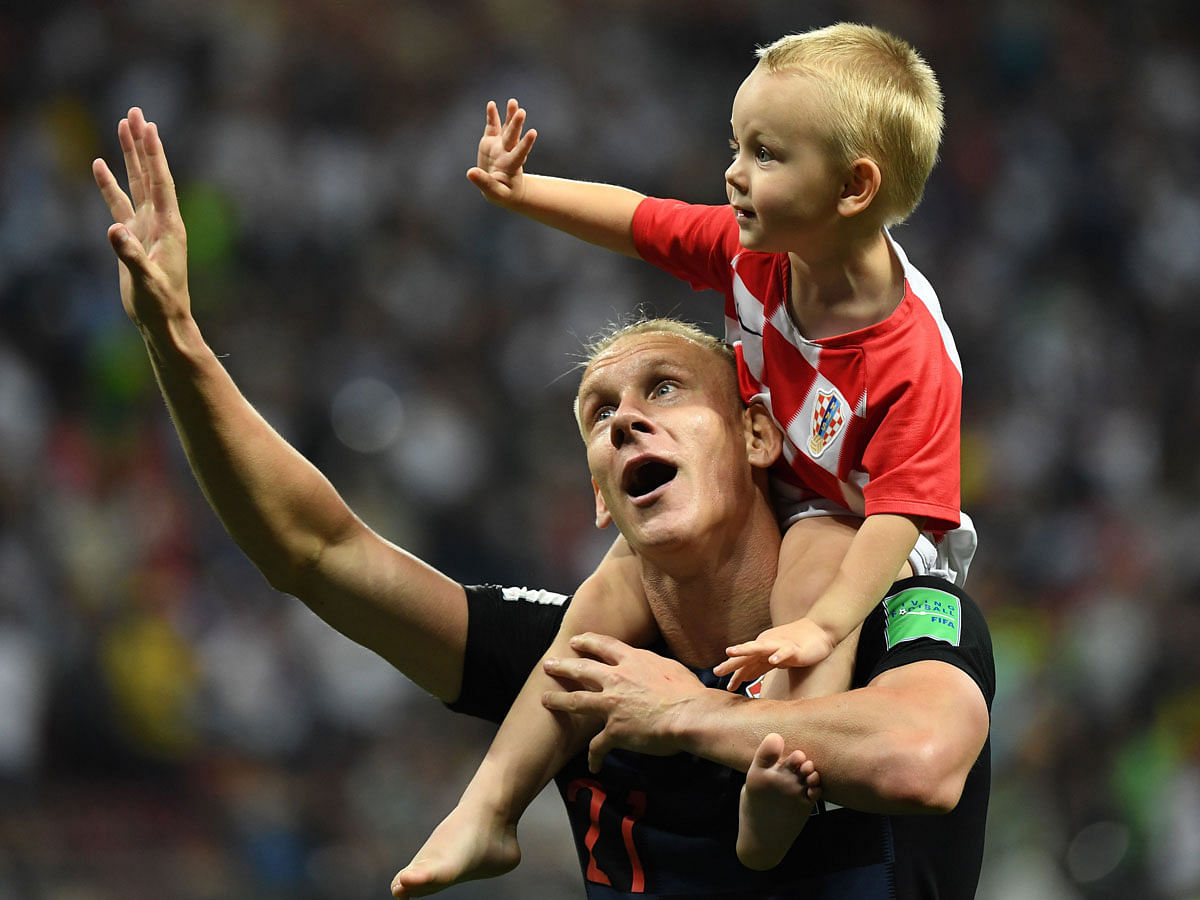 Croatia`s defender Domagoj Vida (L) celebrates with his son David at the end of the Russia 2018 World Cup semi-final football match between Croatia and England at the Luzhniki Stadium in Moscow on 11 July. Photo: AFP