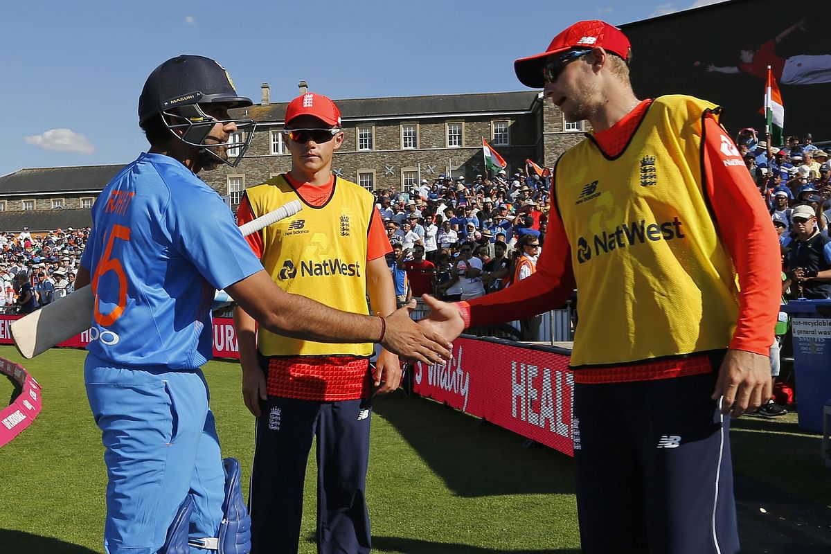 India`s Rohit Sharma shakes hands with England`s Joe Root (R) after the third international Twenty20 cricket match between England and India at The Brightside Ground, Bristol on 8 July 2018. Photo: AFP