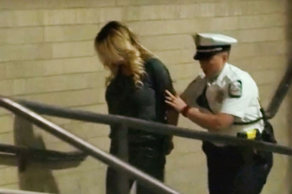 In this frame from video, porn actress Stormy Daniels is led into jail in Columbus, Ohio., after being taken into custody during a Wednesday evening, 11 July, 2018, show. Photo: AP