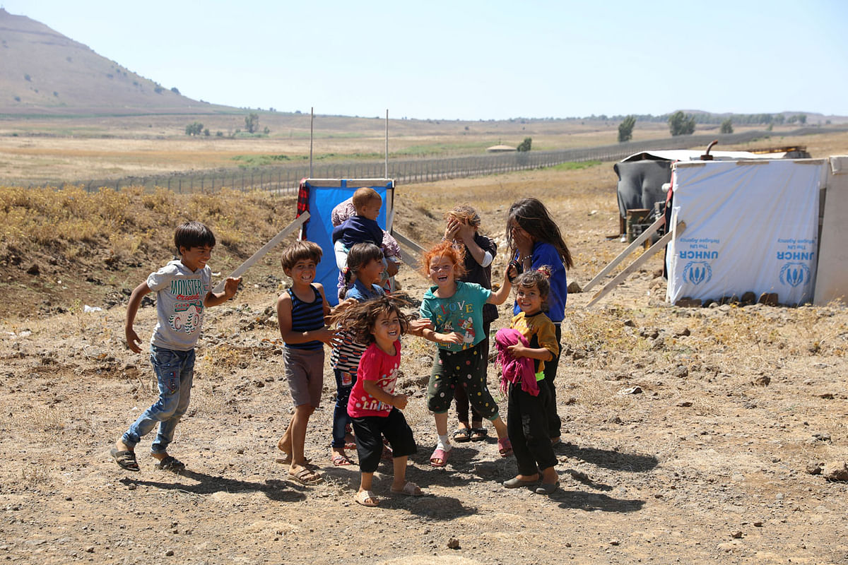 Internally displaced children from Deraa province play together near the Israeli-occupied Golan Heights in Quneitra, Syria on 11 July 2018. Photo: Reuters