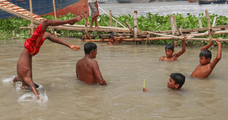 Children along with an adult having fun while bathing in the river. The photo was taken from Khulna Rupsha Kheyaghat on 11 July by Saddam Hossain