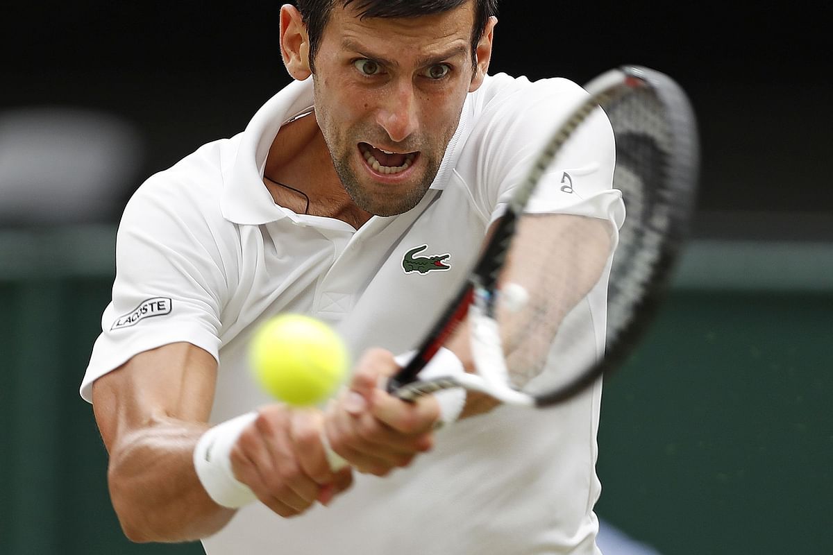 Serbia`s Novak Djokovic returns to Spain`s Rafael Nadal during the continuation of their men`s singles semi-final match on the twelfth day of the 2018 Wimbledon Championships at The All England Lawn Tennis Club in Wimbledon, southwest London, on 14 July, 2018. Photo: AFP