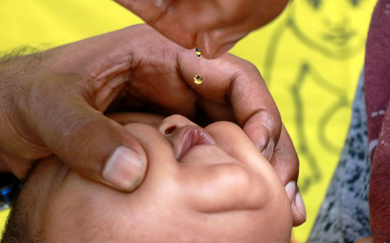 A baby is given Vitamin A capsule in Pabna Sadar hospital, marking the National Vitamin A Plus Campaign- 2018 on 14 July. Photo: Hasan Mahmud
