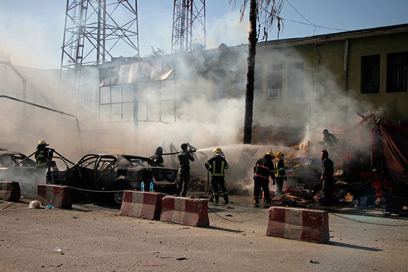 In this 1 July photo, police and firemen work at the site of a deadly suicide attack in Jalalabad, Afghanistan. Photo: AP