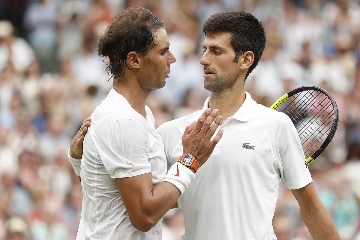 Serbia`s Novak Djokovic (R) shakes hands after beating Spain`s Rafael Nadal during the continuation of their men`s singles semi-final match on the twelfth day of the 2018 Wimbledon Championships at The All England Lawn Tennis Club in Wimbledon, southwest London, on 14 July, 2018. Photo: AFP