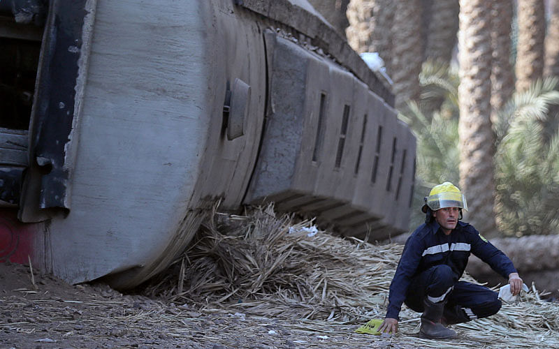 A rescue worker is seen next to a passenger train which derailed in al-Badrasheen area of Giza province, south of Egypt`s capital Cairo, Egypt on 13 July. Photo: Reuters