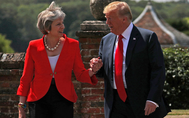 Britain`s Prime Minister Theresa May and U.S. President Donald Trump walk to a joint news conference at Chequers, the official country residence of the Prime Minister, near Aylesbury, Britain on 13 July. Photo: Reuters