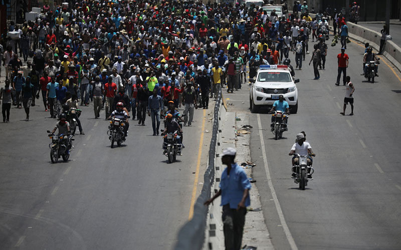Demonstrators march along a street during a protest in Port-au-Prince, Haiti, on 14 July 2018. Photo: Reuters