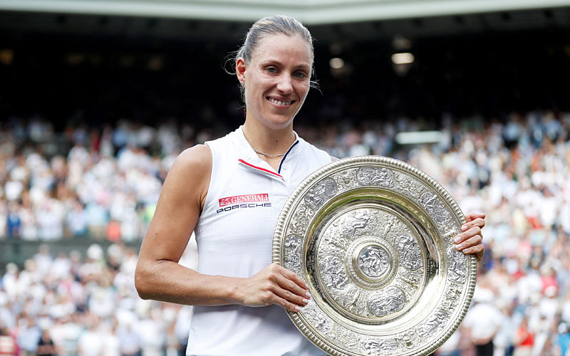 Germany`s Angelique Kerber holds up the Wimbledon trophy after defeating Serena Williams of the US in the women`s singles final at All England Lawn Tennis and Croquet Club, London, Britain on 14 July 2018. Photo: Reuters