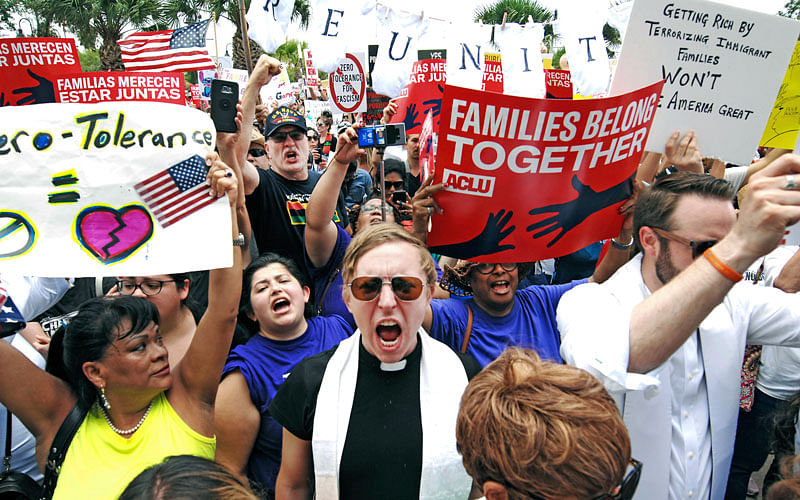 In this 28 June file photo, protesters chant `Families belong together!` as they walk to the front doors of the federal courthouse in Brownsville, Texas, to bring attention to the US immigration policy. Photo: AP