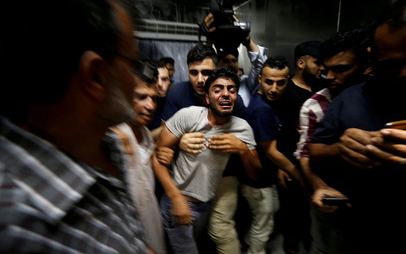 The brother of a Palestinian teenager who was killed in an Israeli air strike, reacts in Gaza City on 14 July 2018. Photo: Reuters