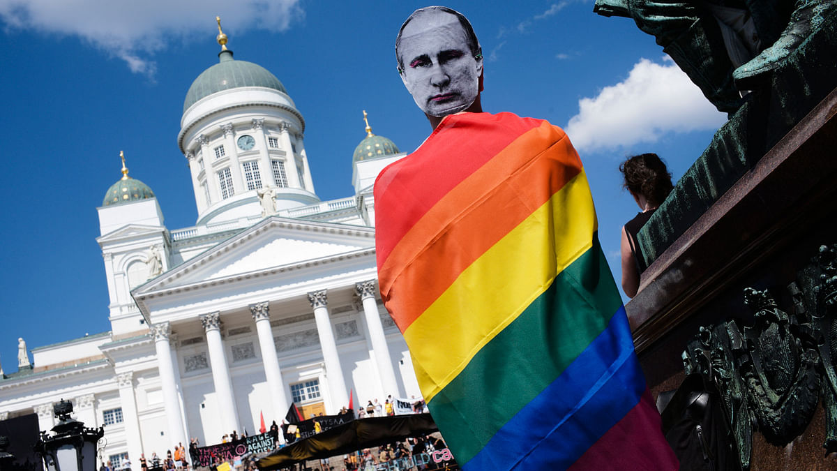 A man with a Putin mask and a rainbow flag attends a rally against the policy of US president Donald Trump and Russian president Vladimir Putin in central Helsinki, Sunday, 15 July 2018. President Trump and president Putin will meet in Finland`s capital on Monday, 16 July 2018.