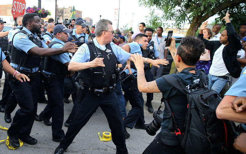 Members of the Chicago police department scuffle with an angry crowd at the scene of a police involved shooting in Chicago, on 14 July. Photo: AP