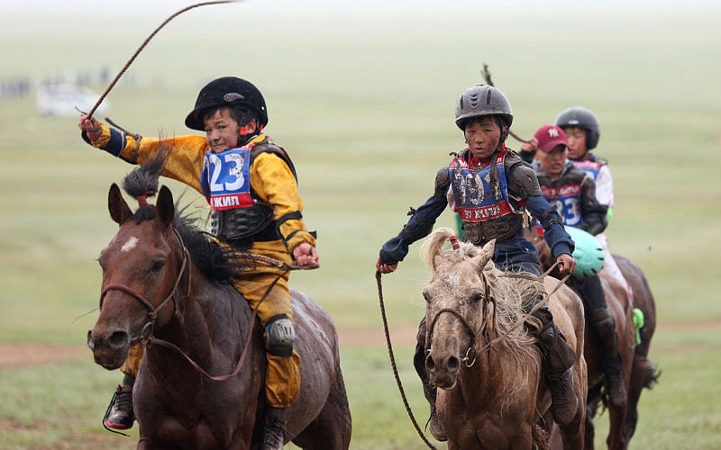 Child jockeys riding horses arrive to the finish line during a horse race at the Mongolian traditional Naadam festival, on the outskirts of Ulaanbaatar, Mongolia on 11 July 2018. Photo: Reuters