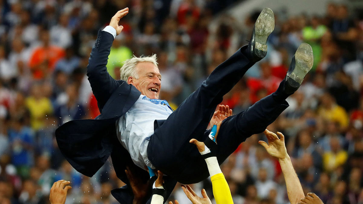 France coach Didier Deschamps is thrown in the air by players as they celebrate winning the World Cup. Photo: Reuters