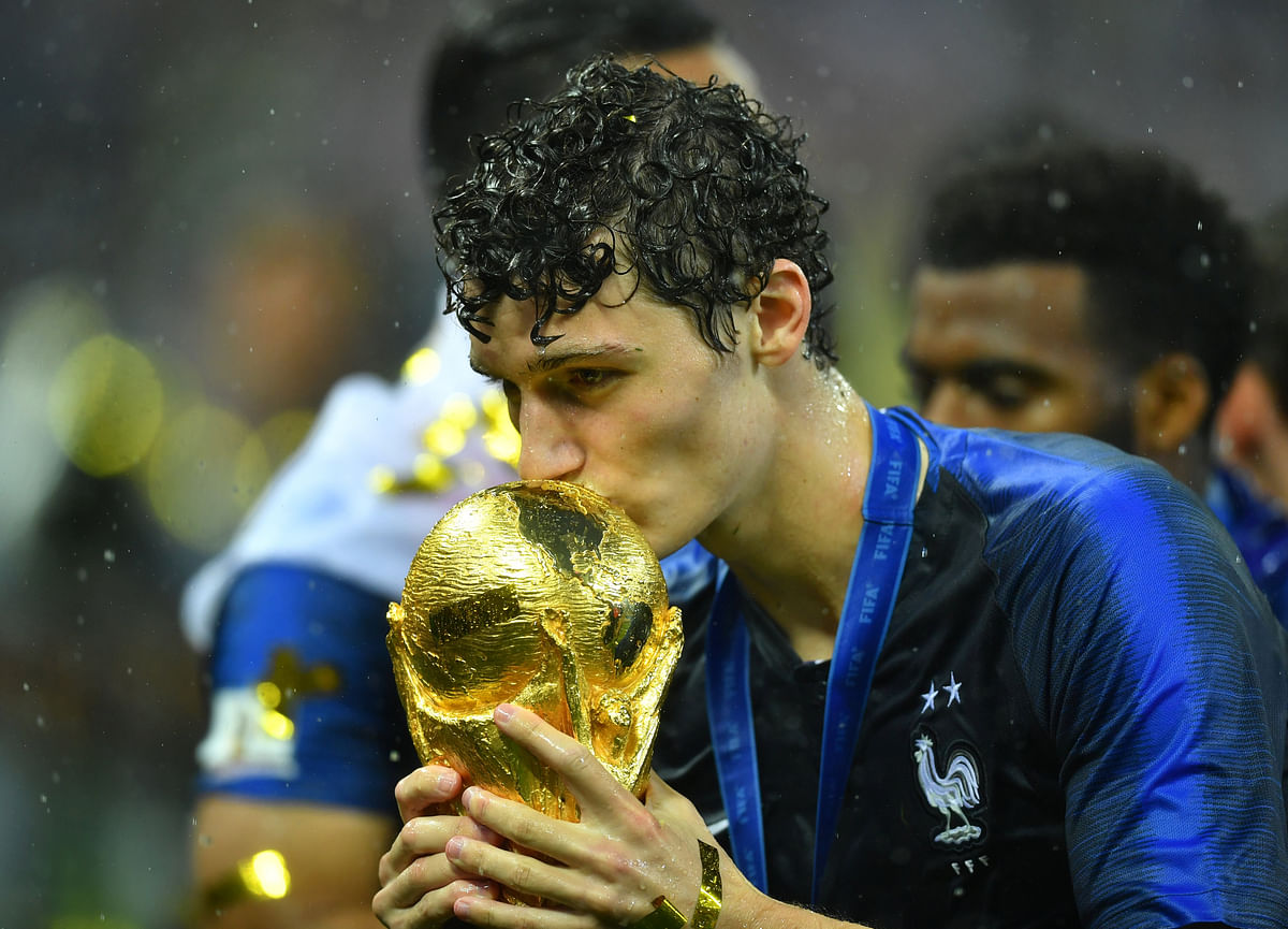 France`s Benjamin Pavard kisses the trophy as he celebrates winning the World Cup REUTERS