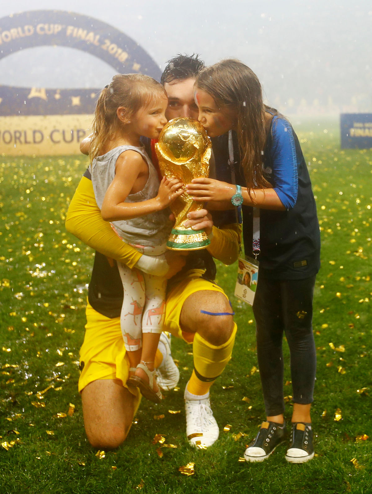 France`s Hugo Lloris and his daughters celebrate with the trophy after winning the World Cup REUTERS