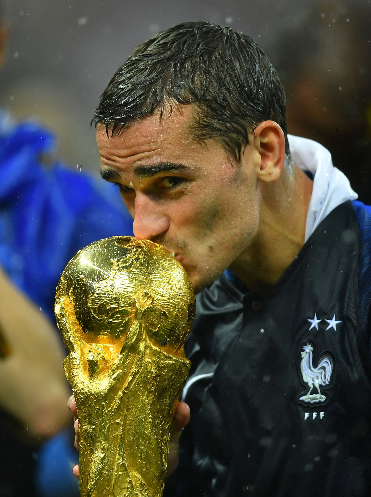 France`s Antoine Griezmann kisses the trophy as he celebrates winning the World Cup REUTERS