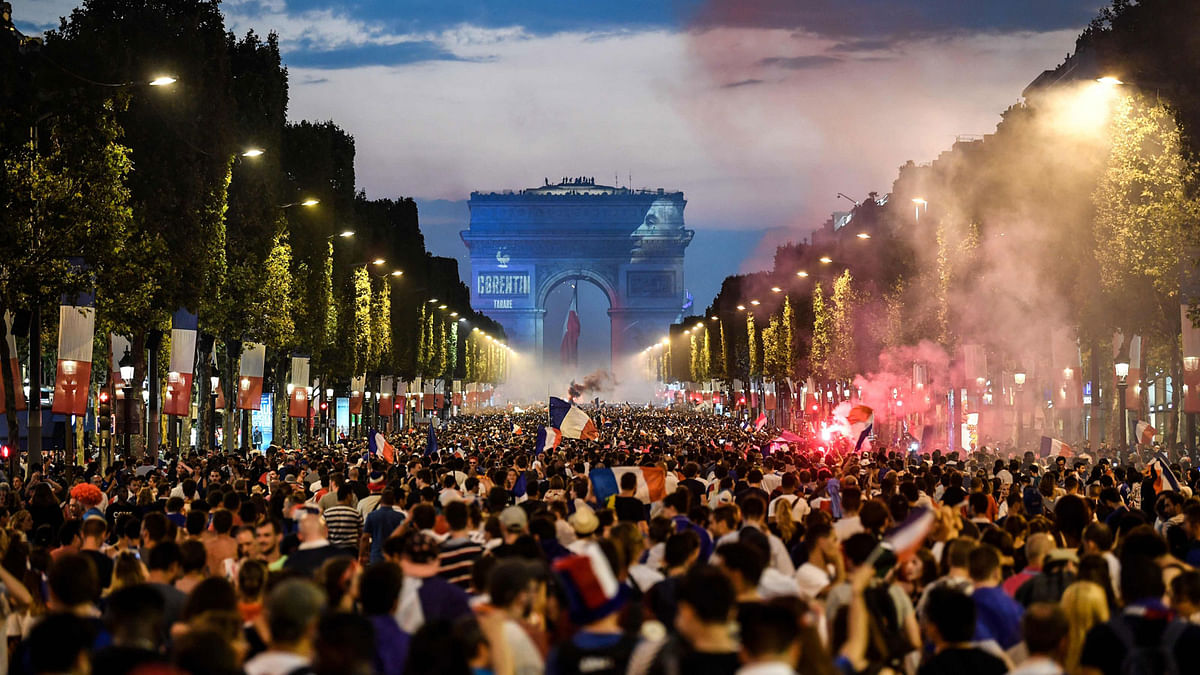 People celebrate France`s victory in the Russia 2018 World Cup final football match between France and Croatia, on the Champs-Elysees avenue on July 15, 2018. Photo: AFP