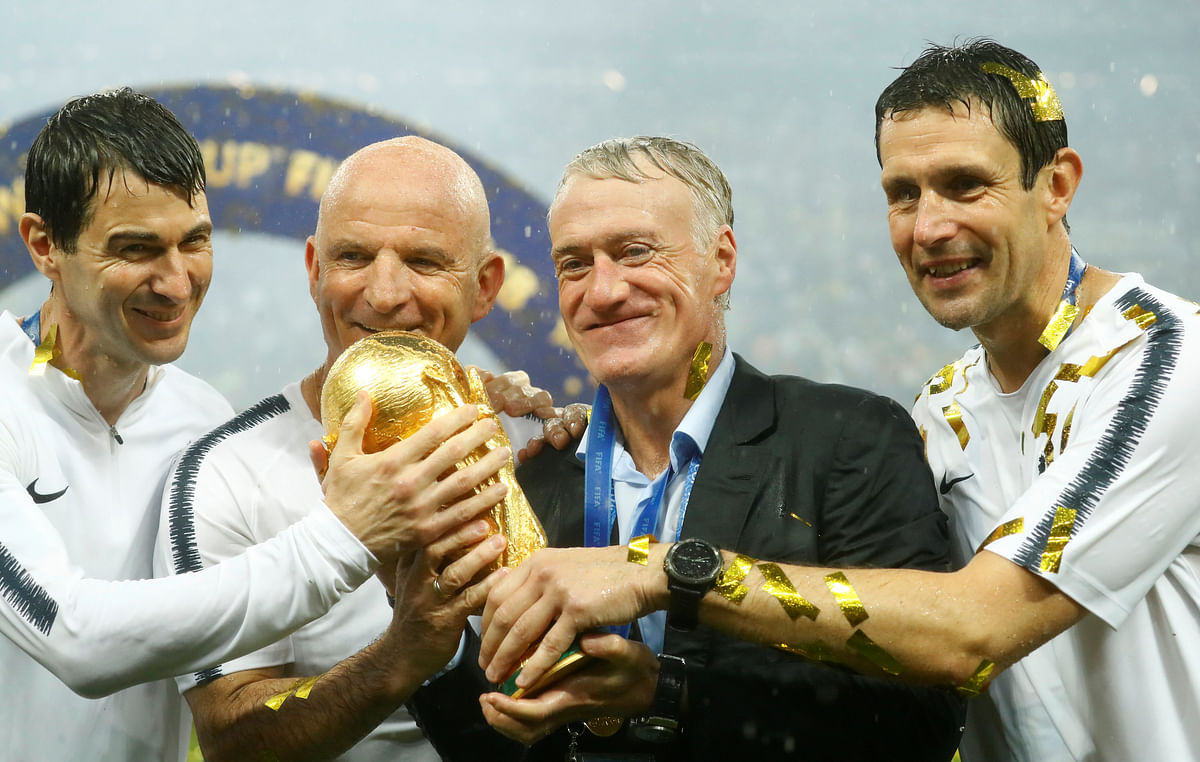France coach Didier Deschamps and assistant coach Guy Stephan celebrate with the trophy after winning the World Cup REUTERS