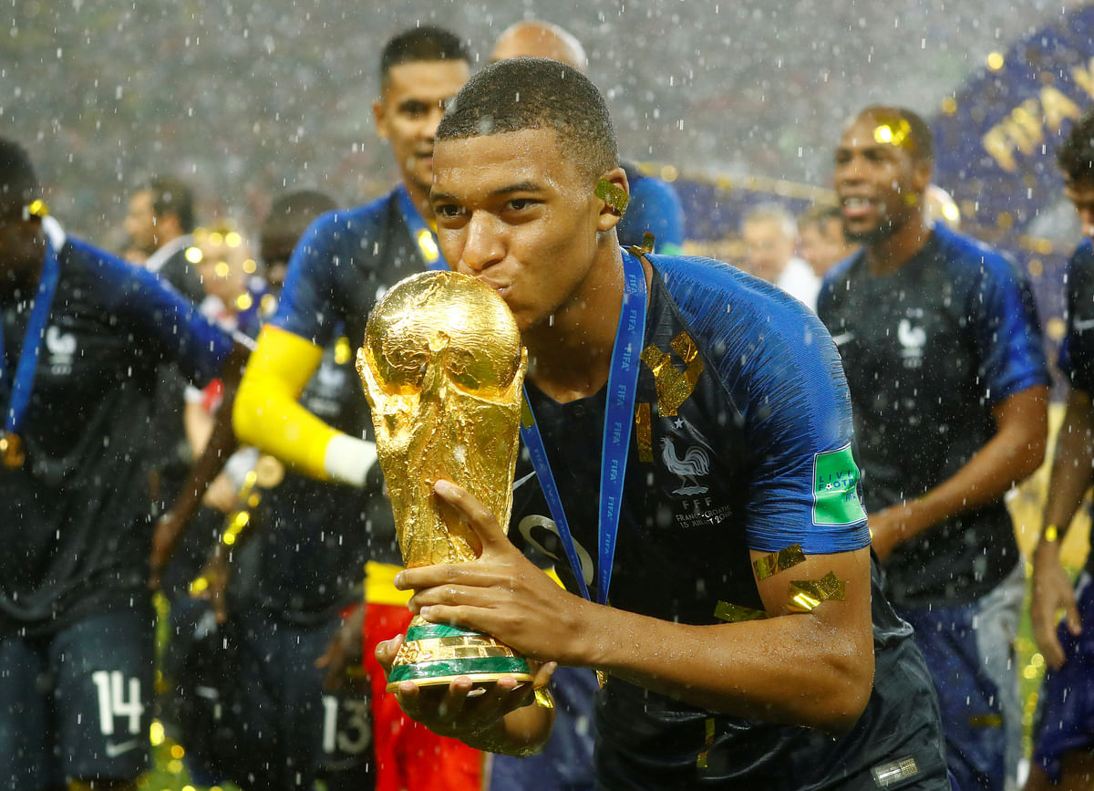 France`s Kylian Mbappe celebrates with the trophy after winning the World Cup REUTERS